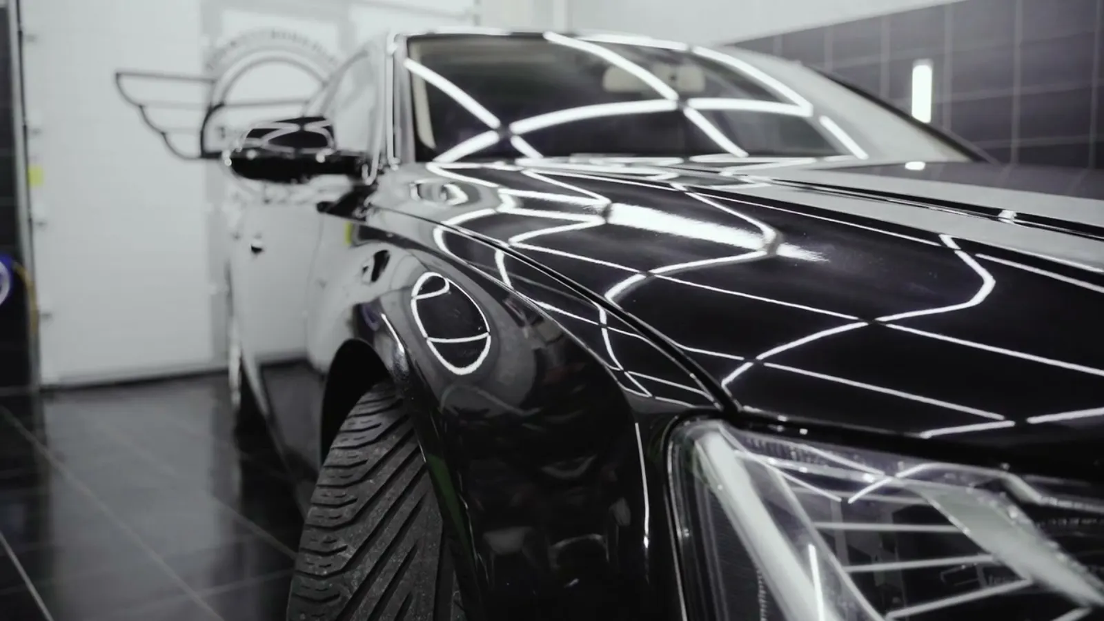 Black luxury car in a detailing studio